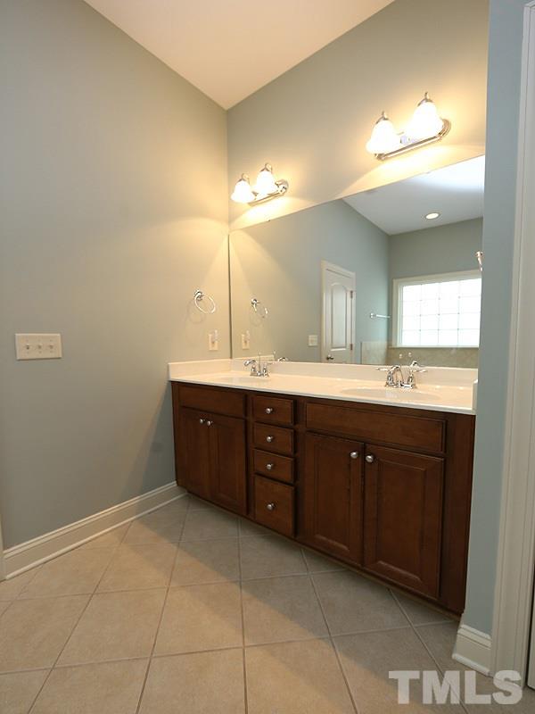 832 Historian Street Raleigh, NC 27603 - Photo 12 of 25 a spacious bathroom with a double vanity sink and a mirror