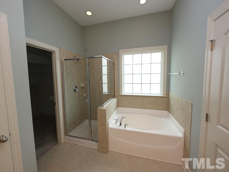 832 Historian Street Raleigh, NC 27603 - Photo 14 of 25 a bathroom with a bathtub and a shower