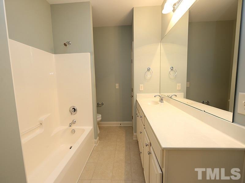 832 Historian Street Raleigh, NC 27603 - Photo 20 of 25 a spacious bathroom with a tub sink and mirror