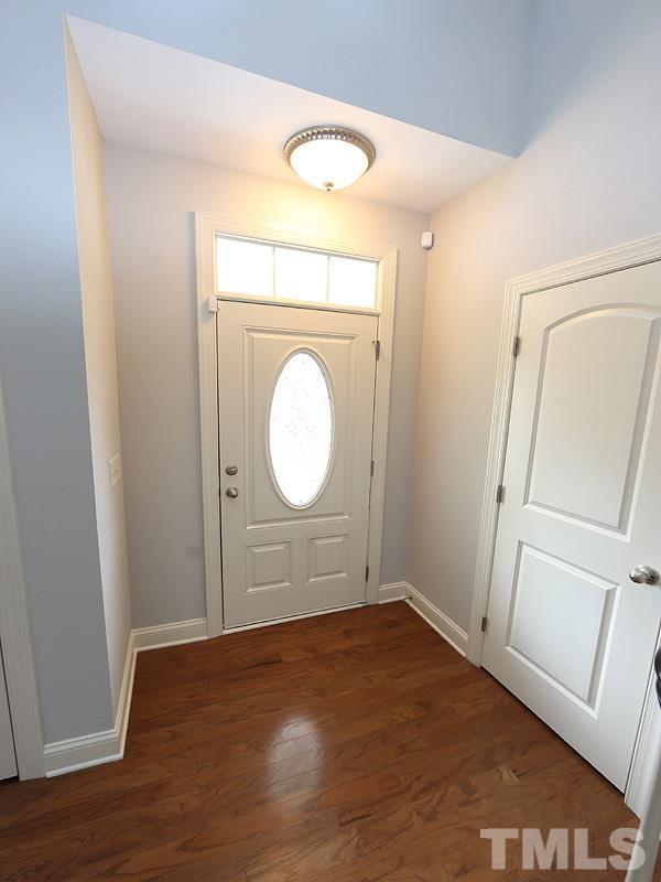 832 Historian Street Raleigh, NC 27603 - Photo 3 of 25 an empty room with wooden floor and window