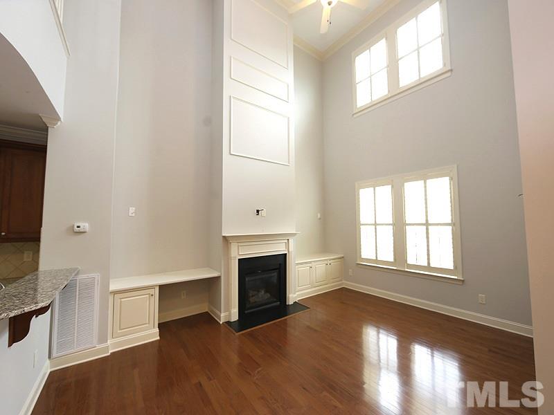 832 Historian Street Raleigh, NC 27603 - Photo 5 of 25 an empty room with windows and fireplace