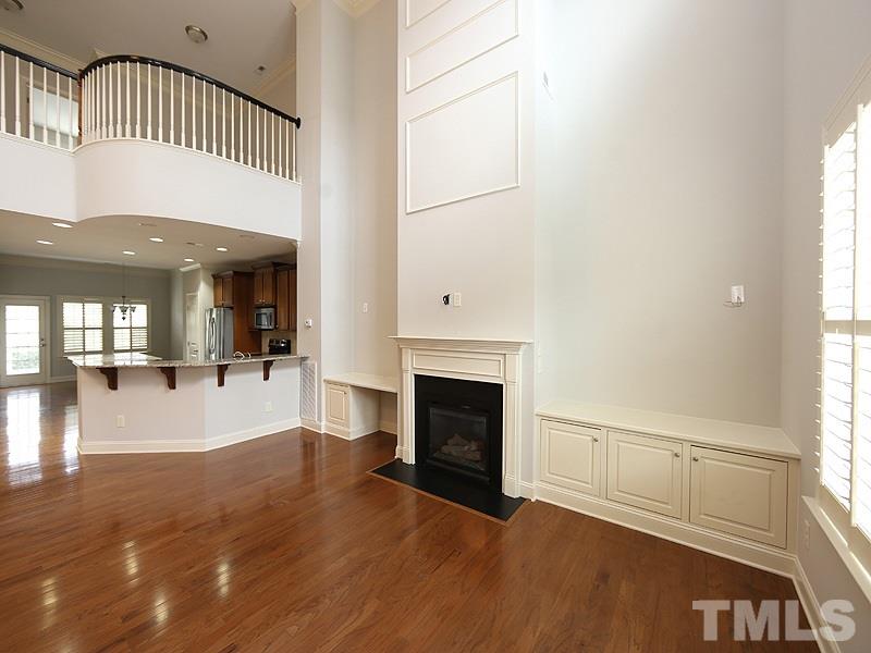 832 Historian Street Raleigh, NC 27603 - Photo 6 of 25 a view of a livingroom with wooden floor and a fireplace
