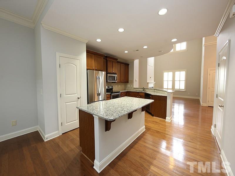 832 Historian Street Raleigh, NC 27603 - Photo 8 of 25 a kitchen with stainless steel appliances granite countertop a sink a refrigerator and a stove