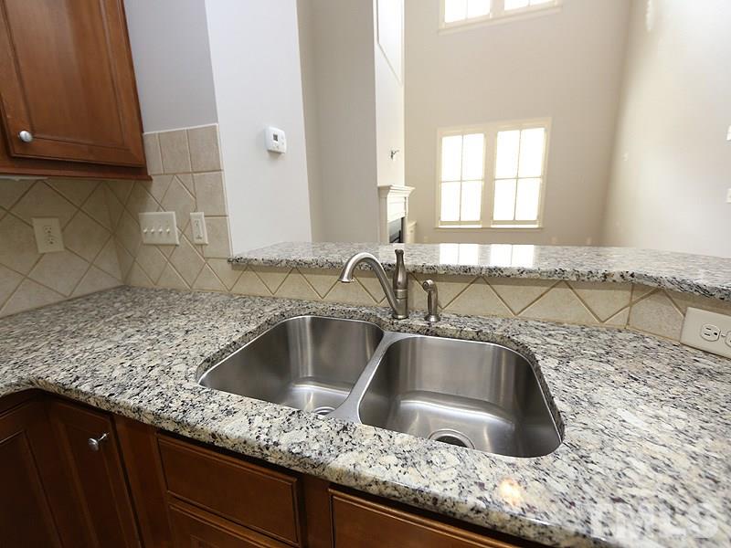 832 Historian Street Raleigh, NC 27603 - Photo 10 of 25 a kitchen with granite countertop a sink and a granite counter tops