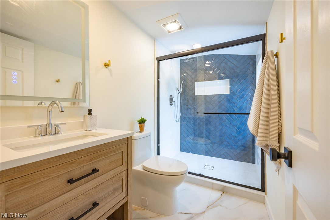 32887 Cedar Road Mayfield Heights, OH 44124 - Photo 30 of 44 Bathroom with vanity, a shower with door, tile floors, and toilet