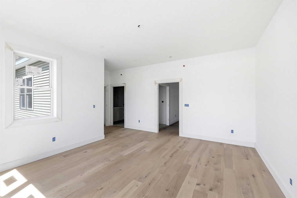 7 Elizabeth Lane, Unit 7 Paxton, MA 01612 - Photo 15 of 30 an empty room with wooden floor and windows