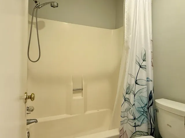 a bathroom with a shower curtain