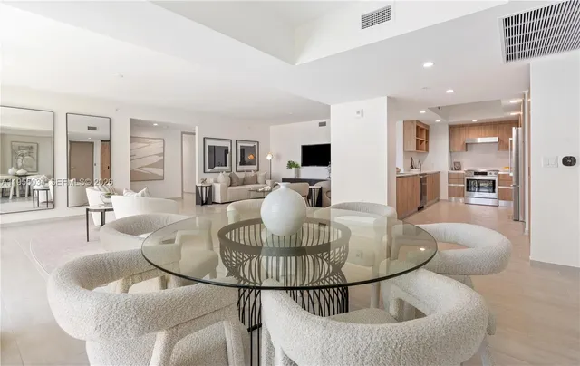 a living room with furniture a dining table and kitchen view
