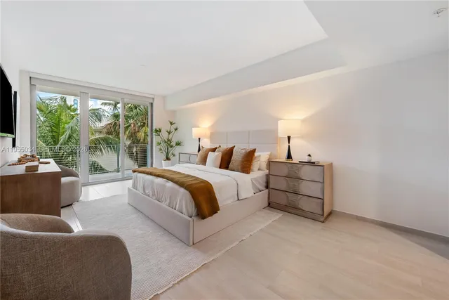 a spacious bedroom with a bed and a couch