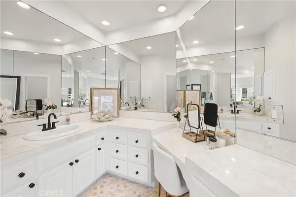 a room with kitchen island a sink and a refrigerator