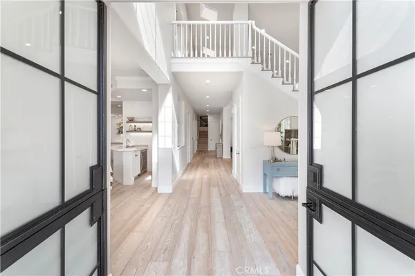 a view of entryway and hall with wooden floor