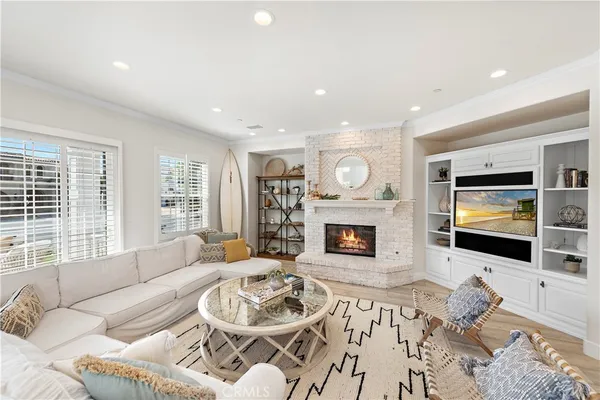 a living room with furniture a fireplace and a flat screen tv