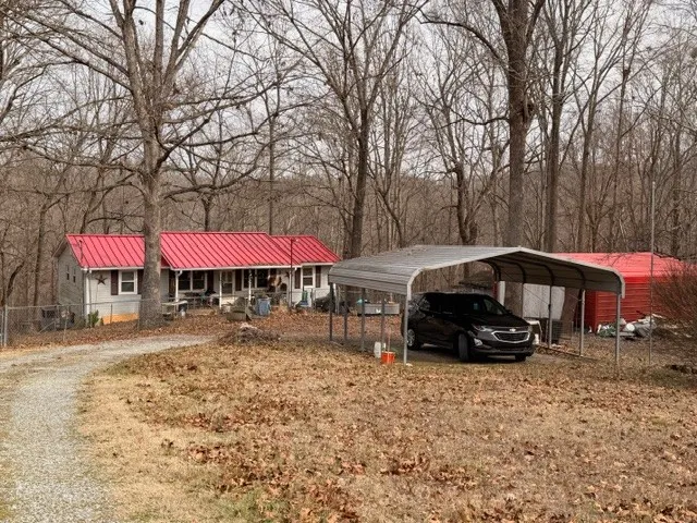 a car parked in front of a white house