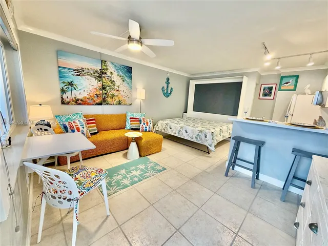 a living room with furniture and painting on the wall