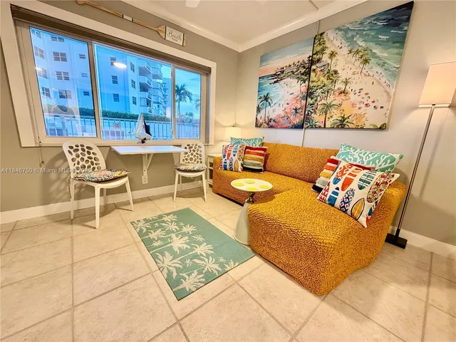 a room with a flat screen tv and a dresser