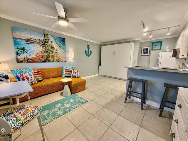 a living room filled with furniture and large windows