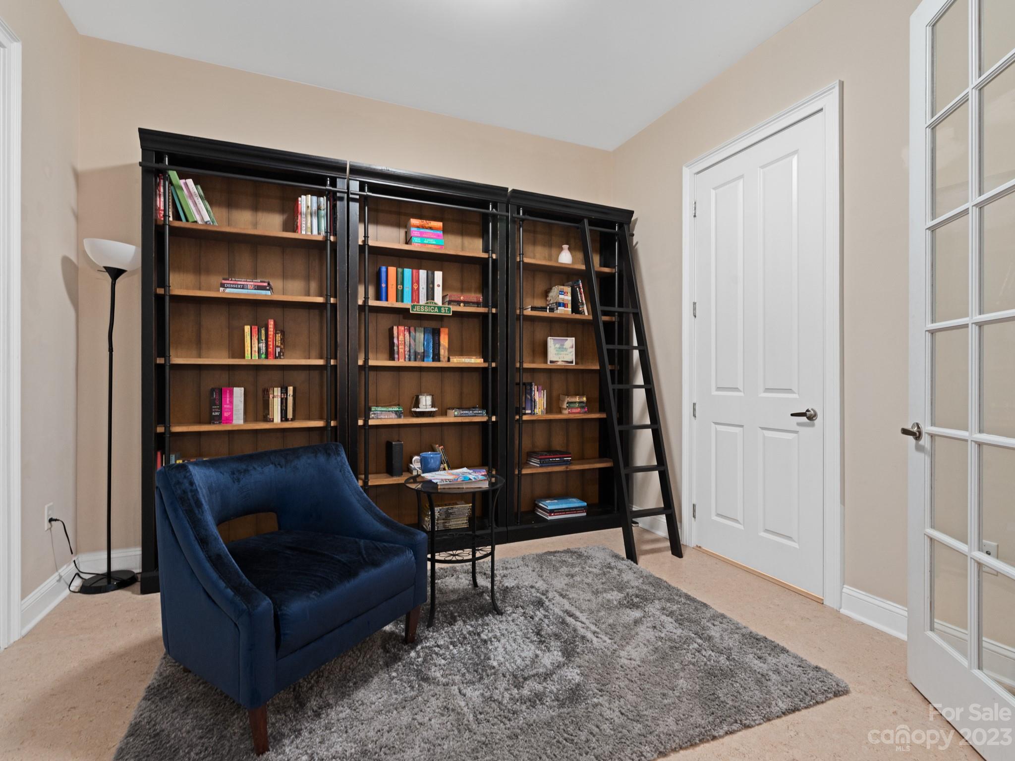 5425 Closeburn Road, Unit 201 Charlotte, NC 28210 - Photo 16 of 35 a living room with a couch and a book shelf