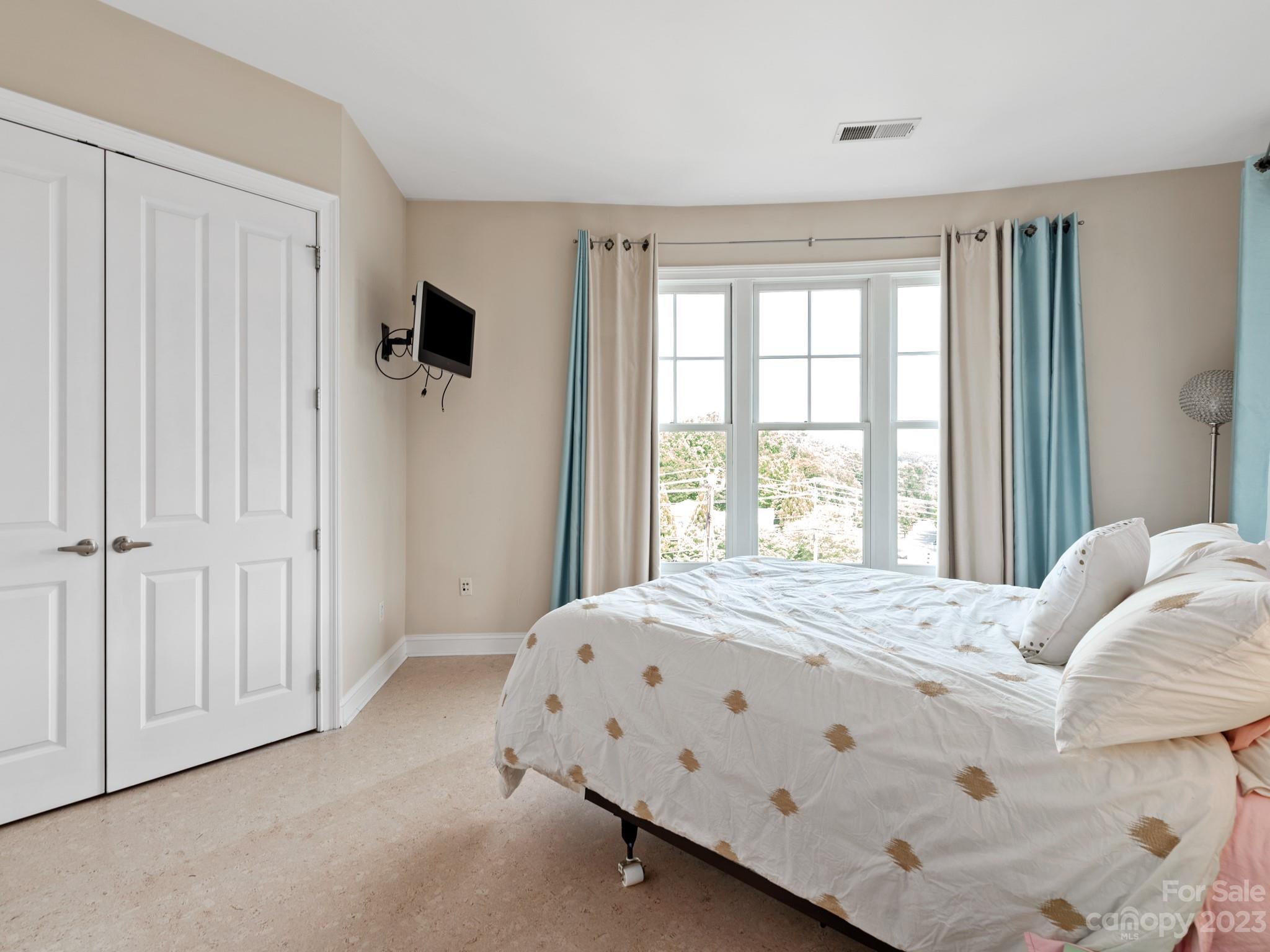 5425 Closeburn Road, Unit 201 Charlotte, NC 28210 - Photo 26 of 35 a bedroom with a bed a window and a mirror