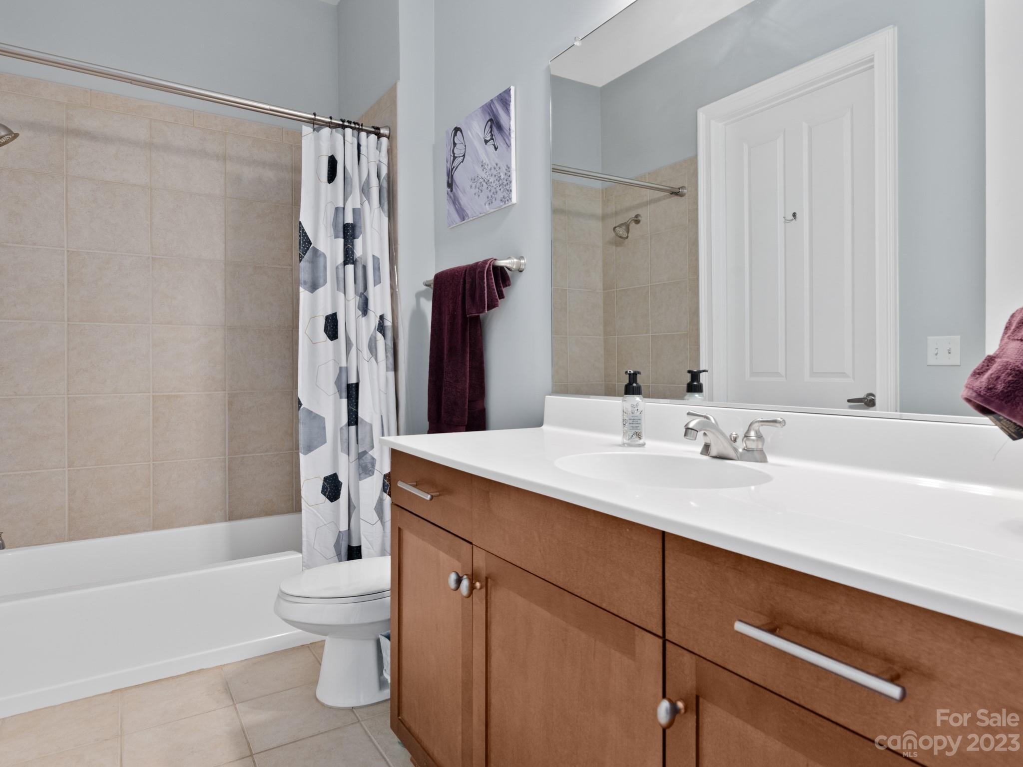 5425 Closeburn Road, Unit 201 Charlotte, NC 28210 - Photo 27 of 35 a bathroom with a sink a toilet and a large mirror