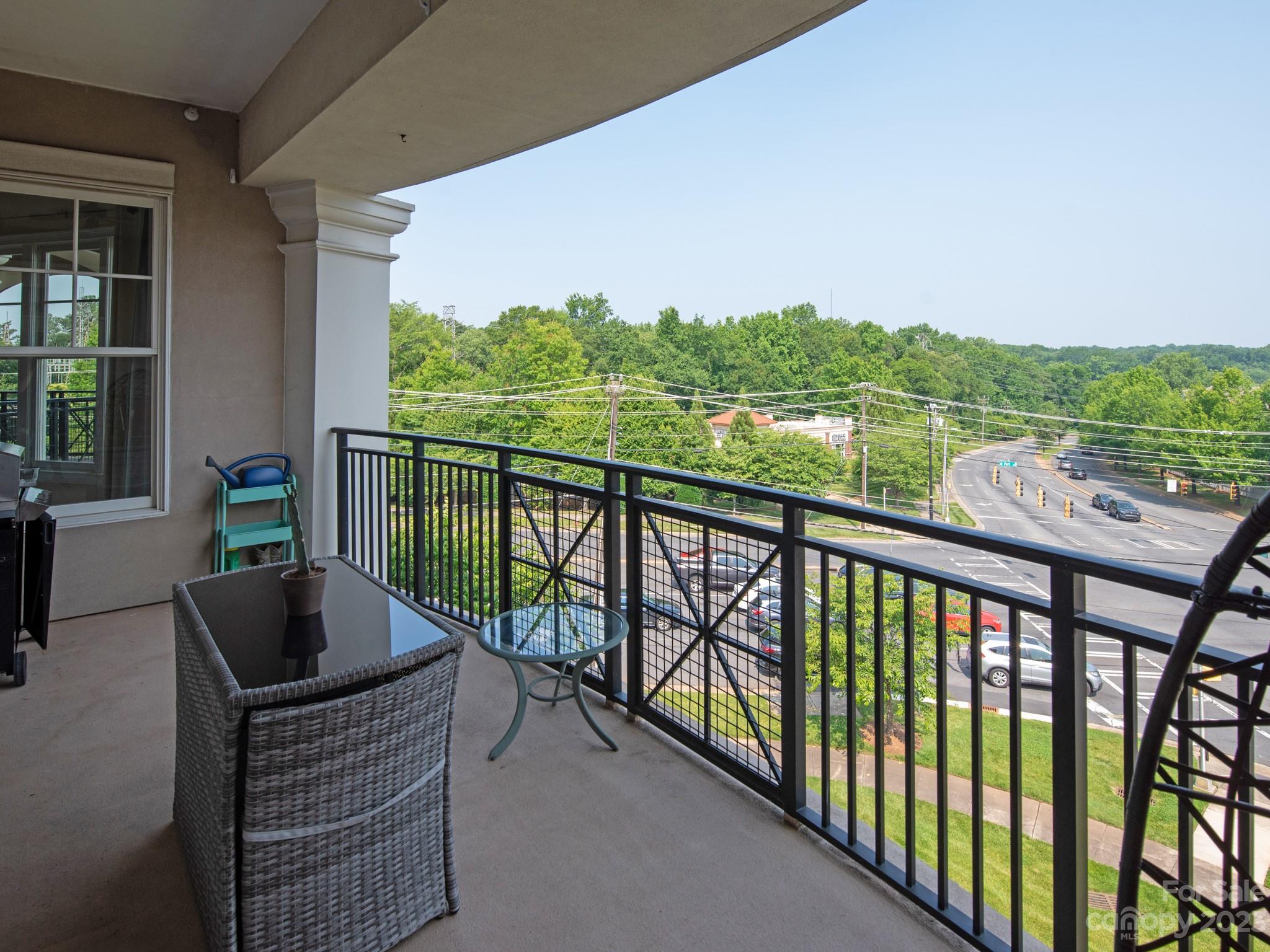 5425 Closeburn Road, Unit 201 Charlotte, NC 28210 - Photo 3 of 35 a view of a two chairs and table in the balcony