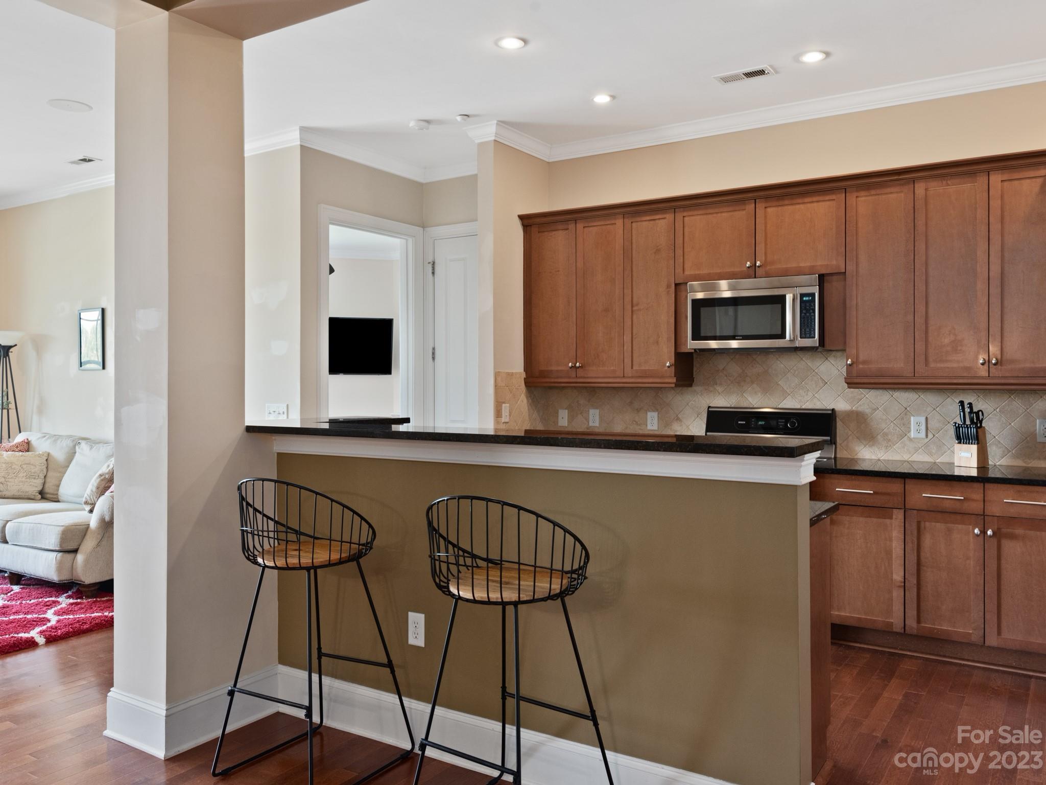5425 Closeburn Road, Unit 201 Charlotte, NC 28210 - Photo 4 of 35 a kitchen with stainless steel appliances granite countertop a stove a sink and a microwave