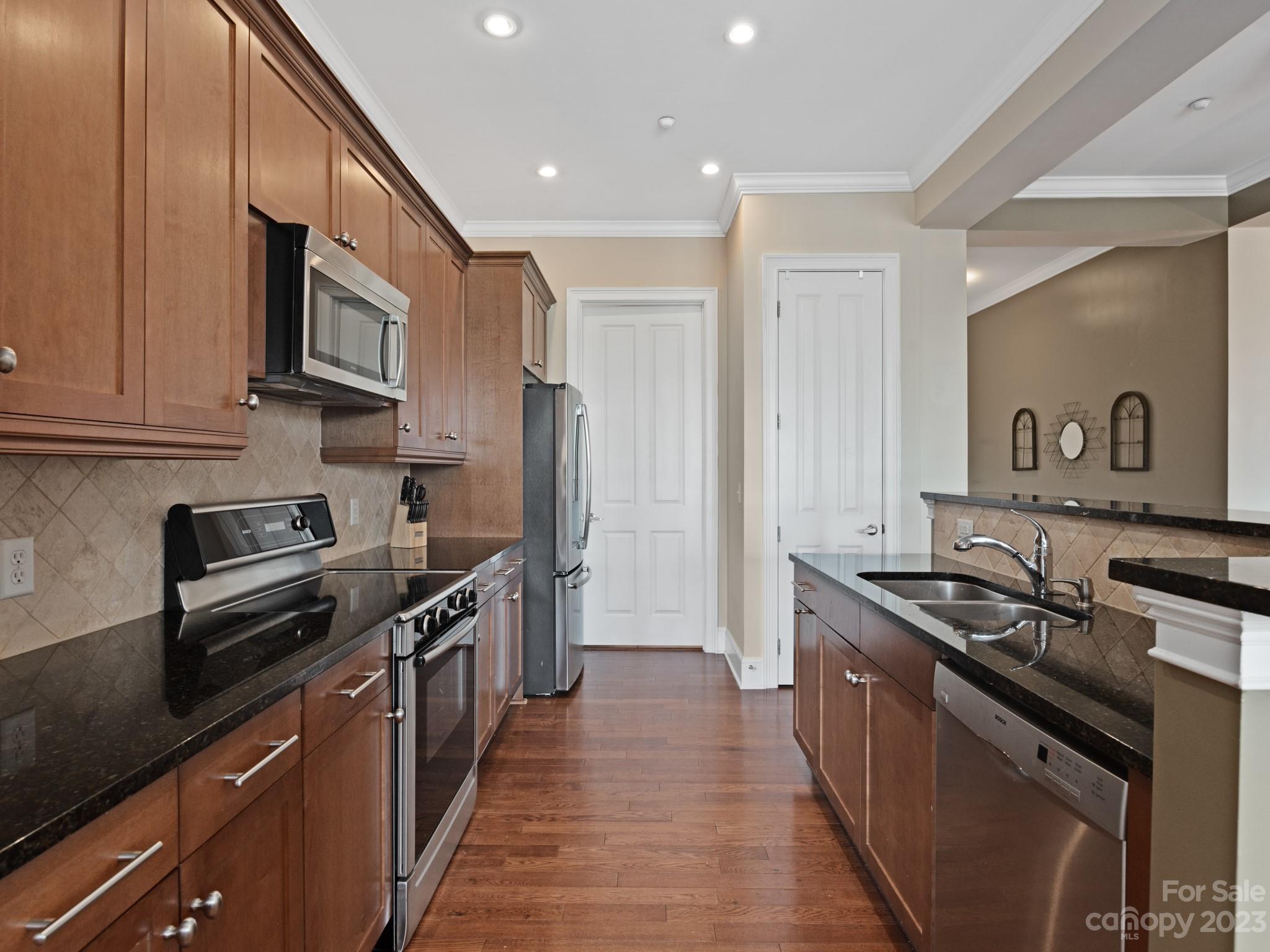 5425 Closeburn Road, Unit 201 Charlotte, NC 28210 - Photo 5 of 35 a kitchen with stainless steel appliances granite countertop a stove a sink and a refrigerator