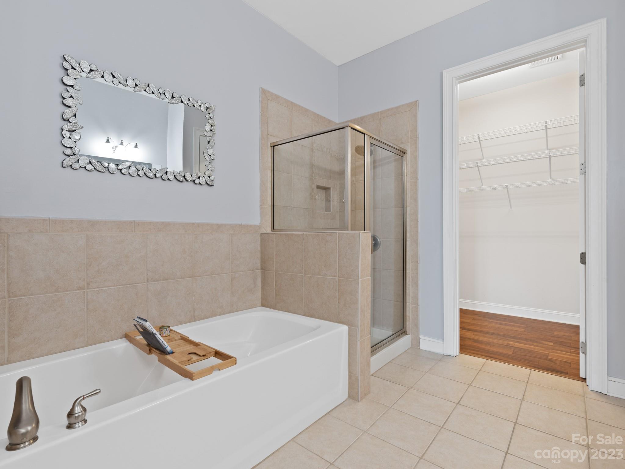 5425 Closeburn Road, Unit 201 Charlotte, NC 28210 - Photo 9 of 35 a bathroom with a tub and shower