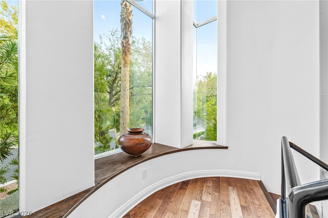 2000 Grouse Street Las Vegas, NV 89134 - Photo 31 of 89 Floor-to-ceiling glass panels illuminate this stair landing, offering verdant outdoor views.