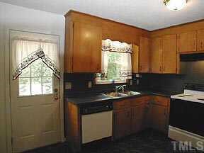 4709 Forestdale Road Raleigh, NC 27603 - Photo 4 of 10 a kitchen with sink a window and cabinets