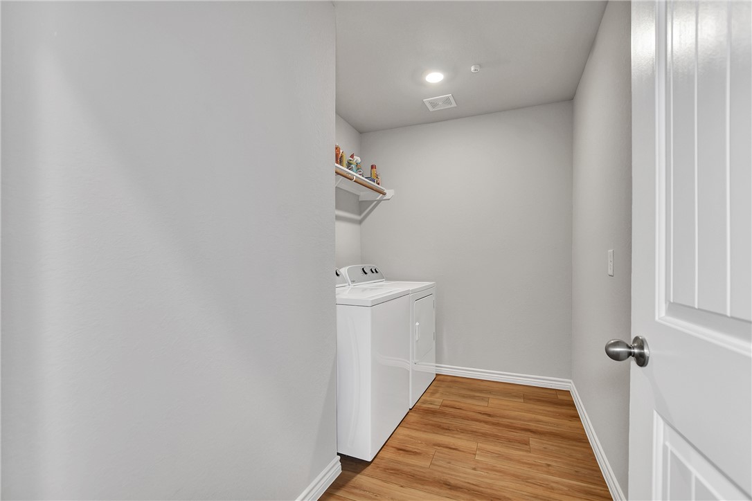909 Davy Street Brenham, TX 77833 - Photo 25 of 35 Laundry room featuring light wood finished floors, and recessed lighting