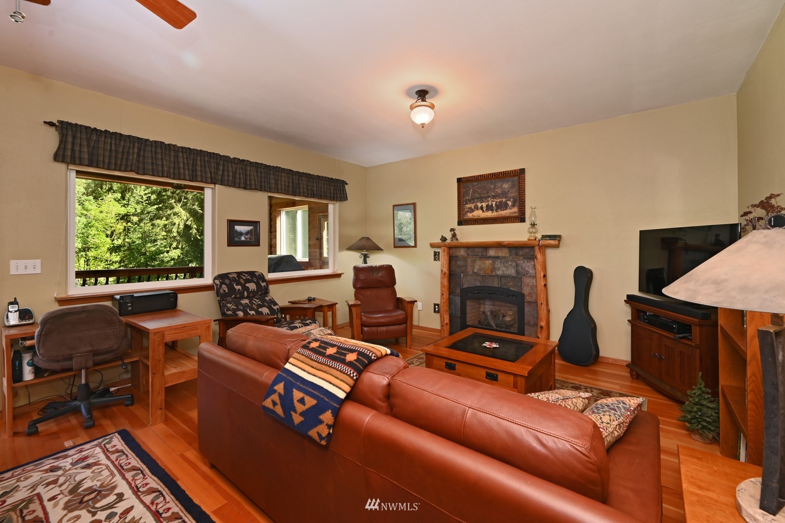 52133 South Riverside Road Gold Bar, WA 98251 - Photo 12 of 40 a living room with furniture large window and a fireplace