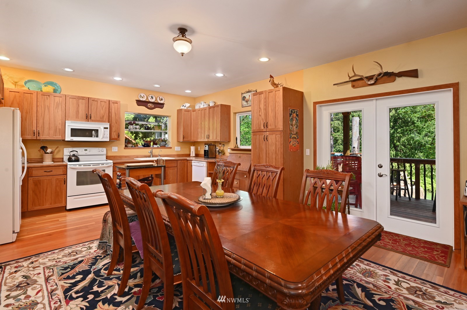 52133 South Riverside Road Gold Bar, WA 98251 - Photo 13 of 40 a view of a dining room with furniture window and wooden floor