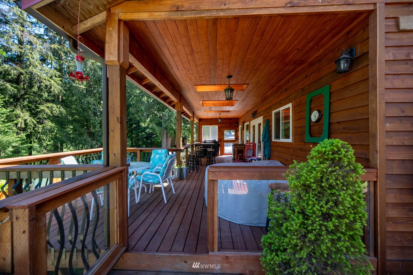 52133 South Riverside Road Gold Bar, WA 98251 - Photo 15 of 40 a view of a balcony with chairs and wooden floor