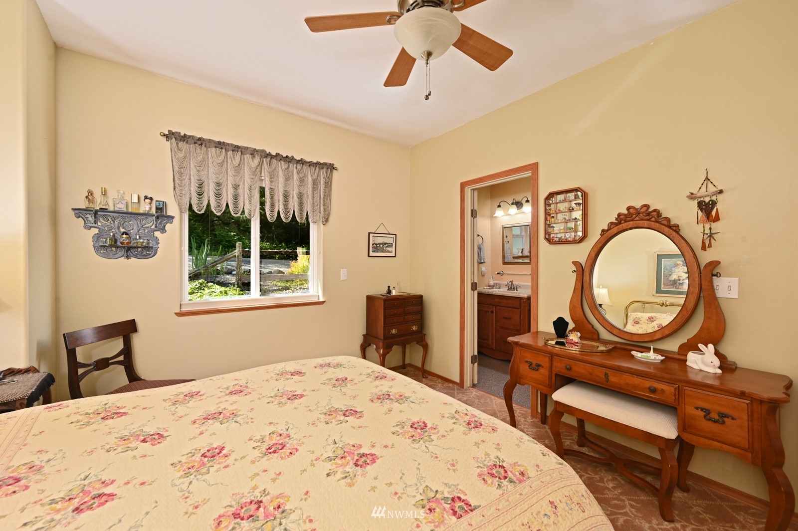 52133 South Riverside Road Gold Bar, WA 98251 - Photo 18 of 40 a bedroom with a bed a dresser and chair