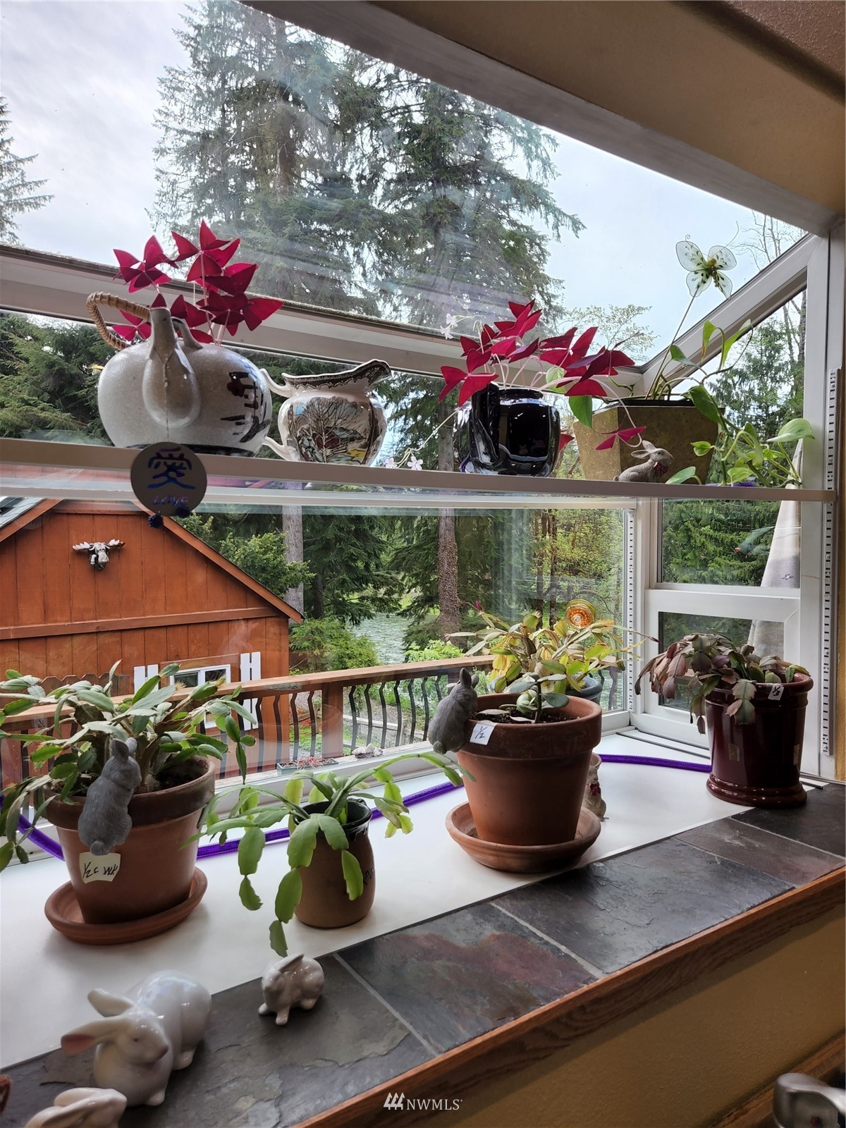52133 South Riverside Road Gold Bar, WA 98251 - Photo 8 of 40 a view of a porch with furniture and a potted plant