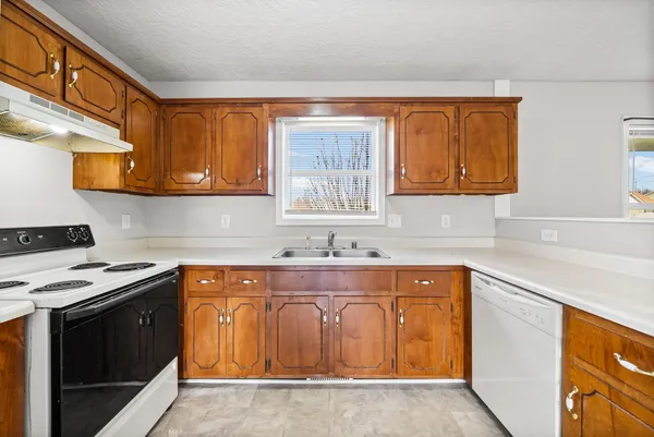 a kitchen with stainless steel appliances granite countertop a sink and cabinets