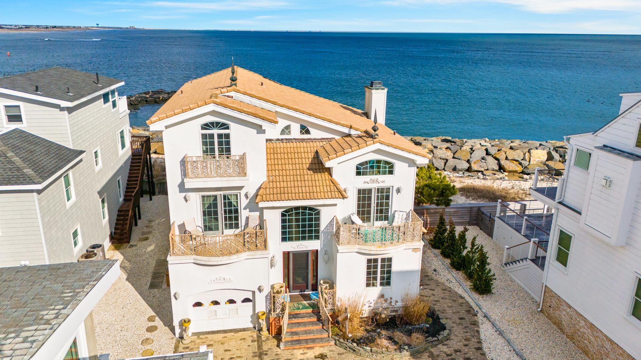 283 6th Street Avalon, NJ 08202 - Photo 1 of 36 a view of a brick house with plants and wooden fence