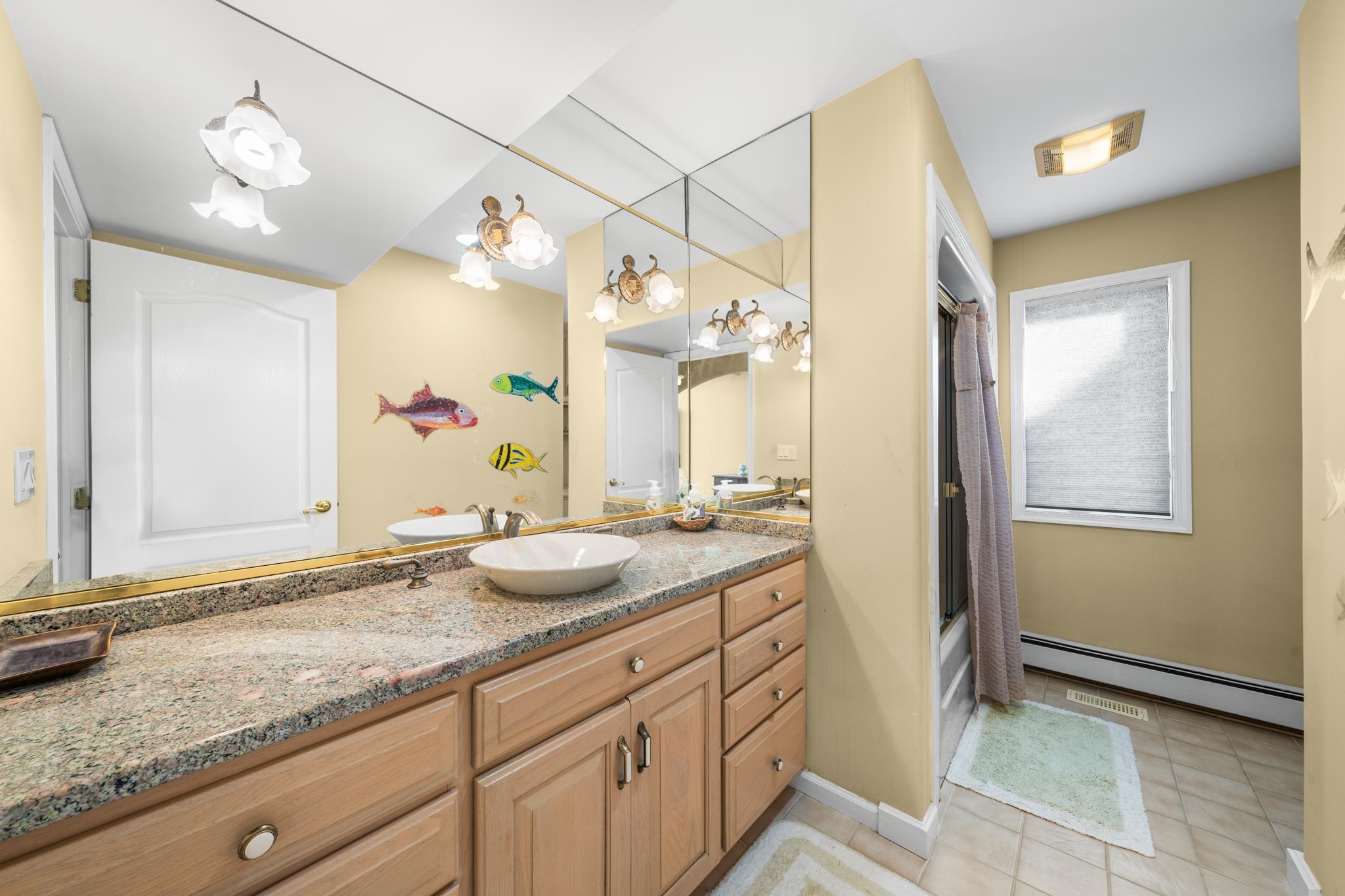 283 6th Street Avalon, NJ 08202 - Photo 23 of 36 a bathroom with a granite countertop sink and a mirror