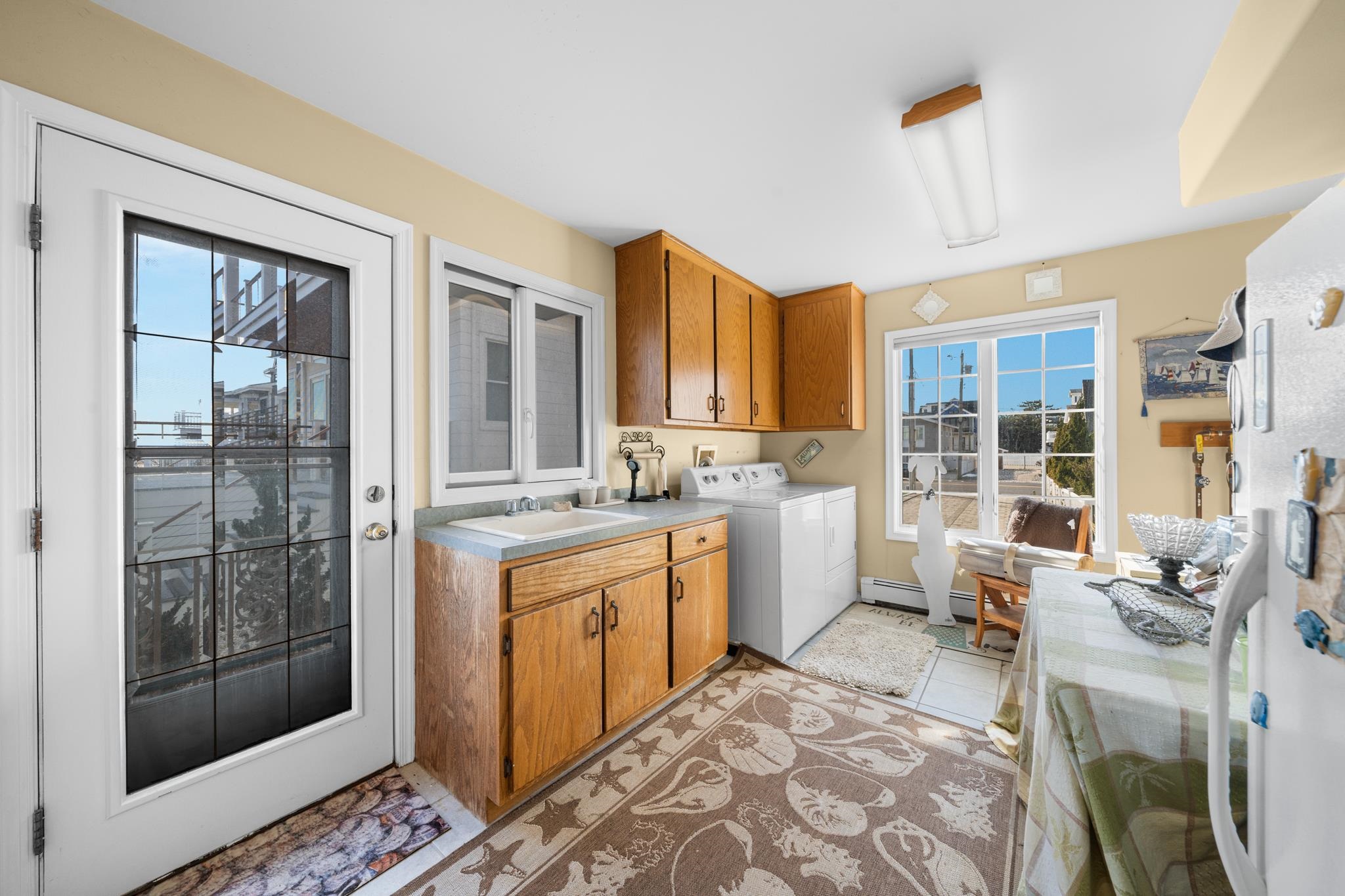 283 6th Street Avalon, NJ 08202 - Photo 24 of 36 a large living room with stainless steel appliances granite countertop furniture a rug a lamp and windows
