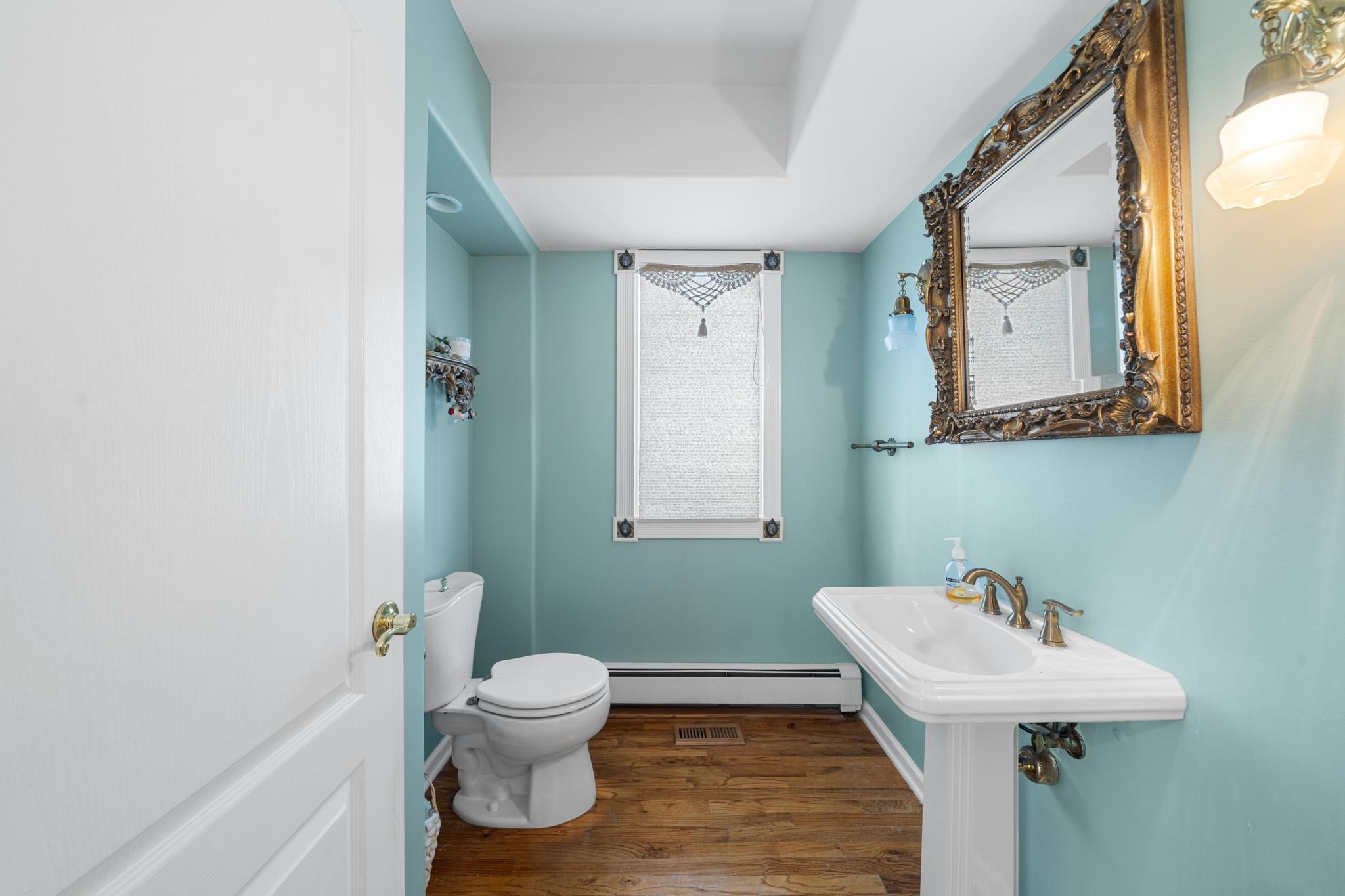 283 6th Street Avalon, NJ 08202 - Photo 26 of 36 a bathroom with a toilet a sink and mirror