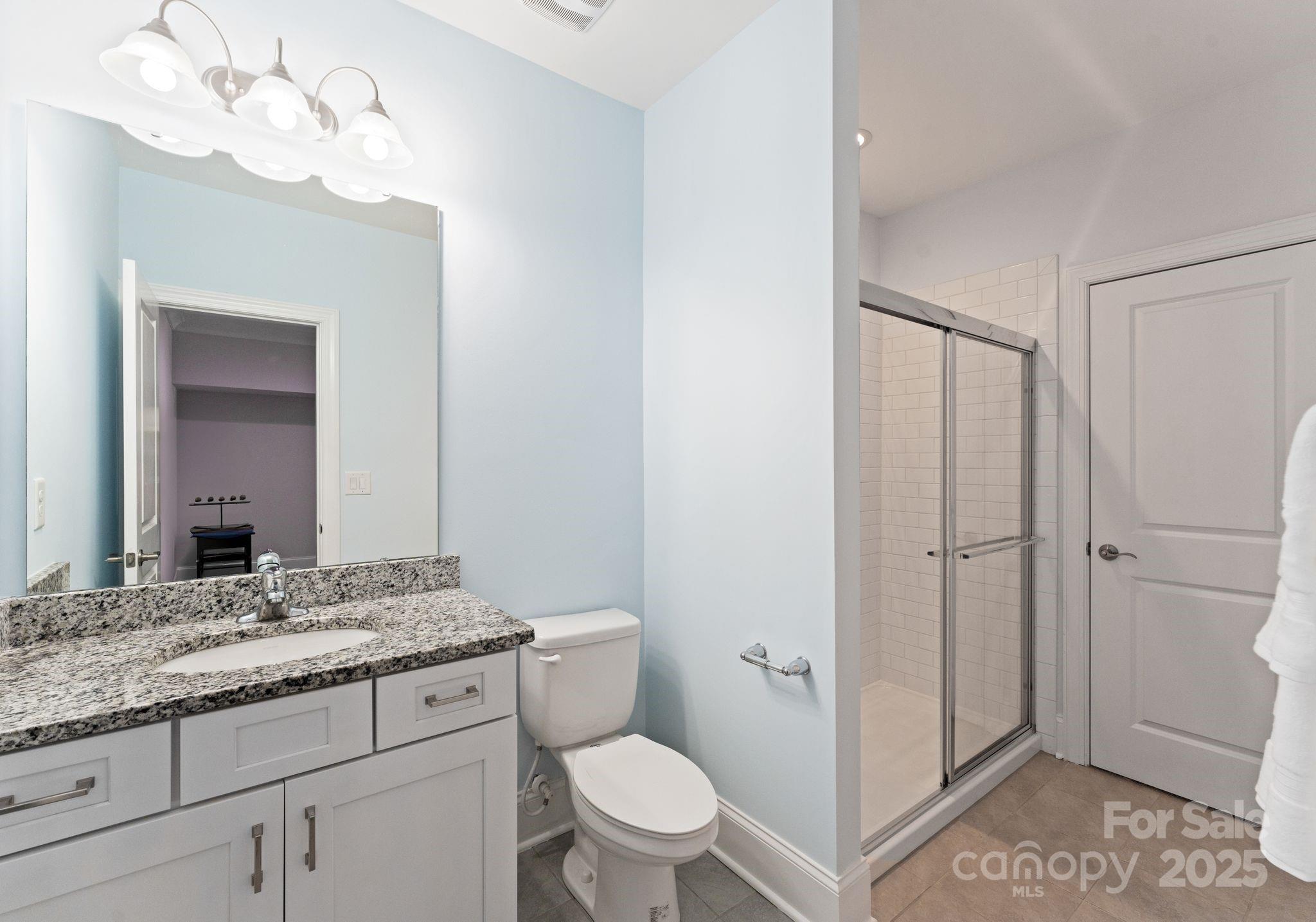 3239 Split Rail Lane Lancaster, SC 29720 - Photo 30 of 39 a bathroom with a granite countertop sink a toilet and a mirror