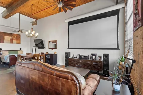 a view of a livingroom with furniture and a flat screen tv