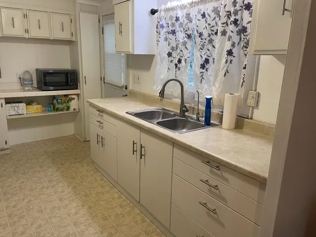 a kitchen with stainless steel appliances a sink and cabinets