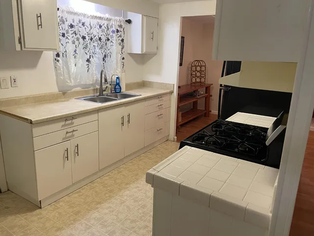 a kitchen with a sink stove and refrigerator