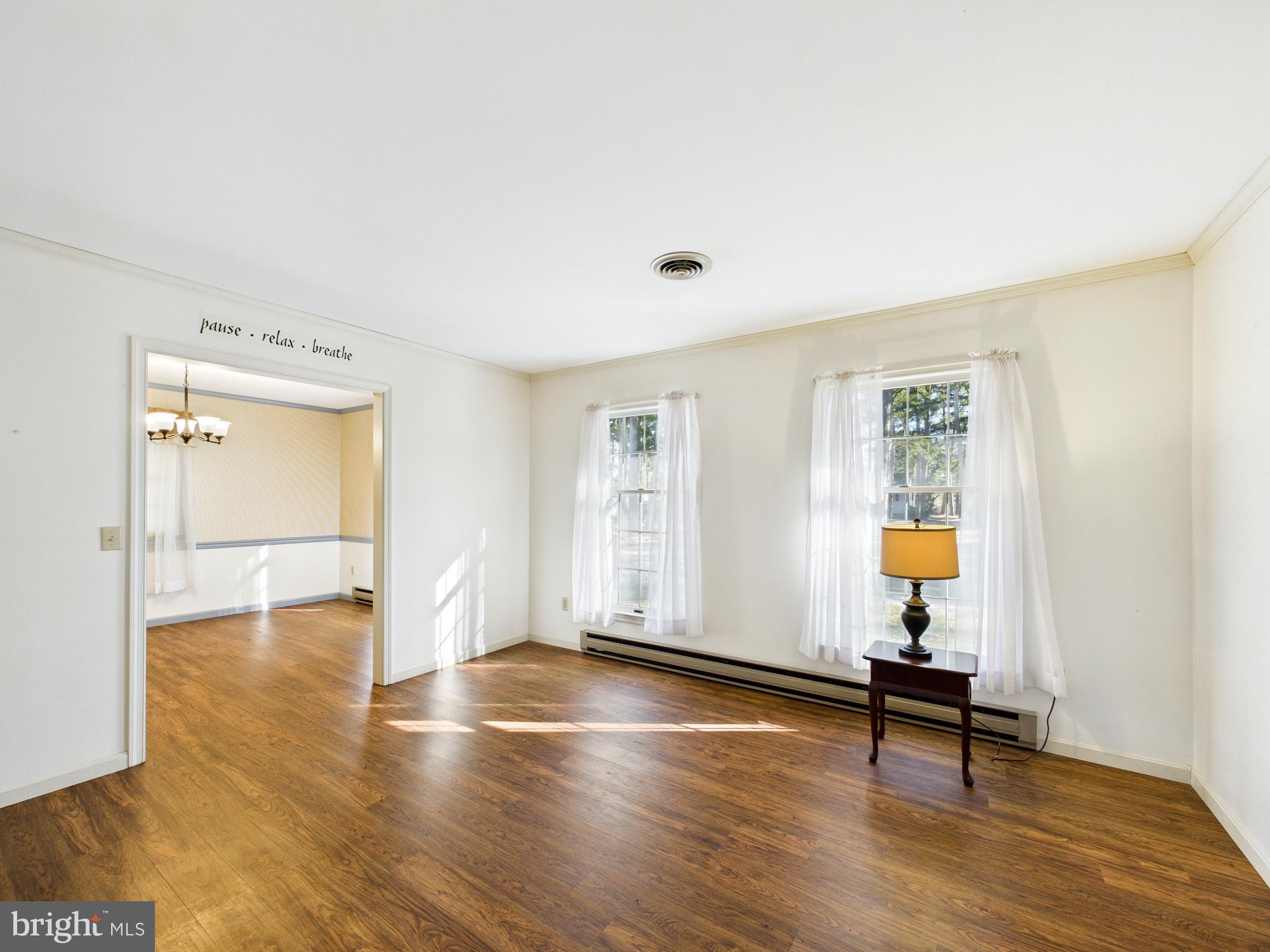 5046 Manokin Road Crisfield, MD 21817 - Photo 17 of 72 an empty room with wooden floor and windows