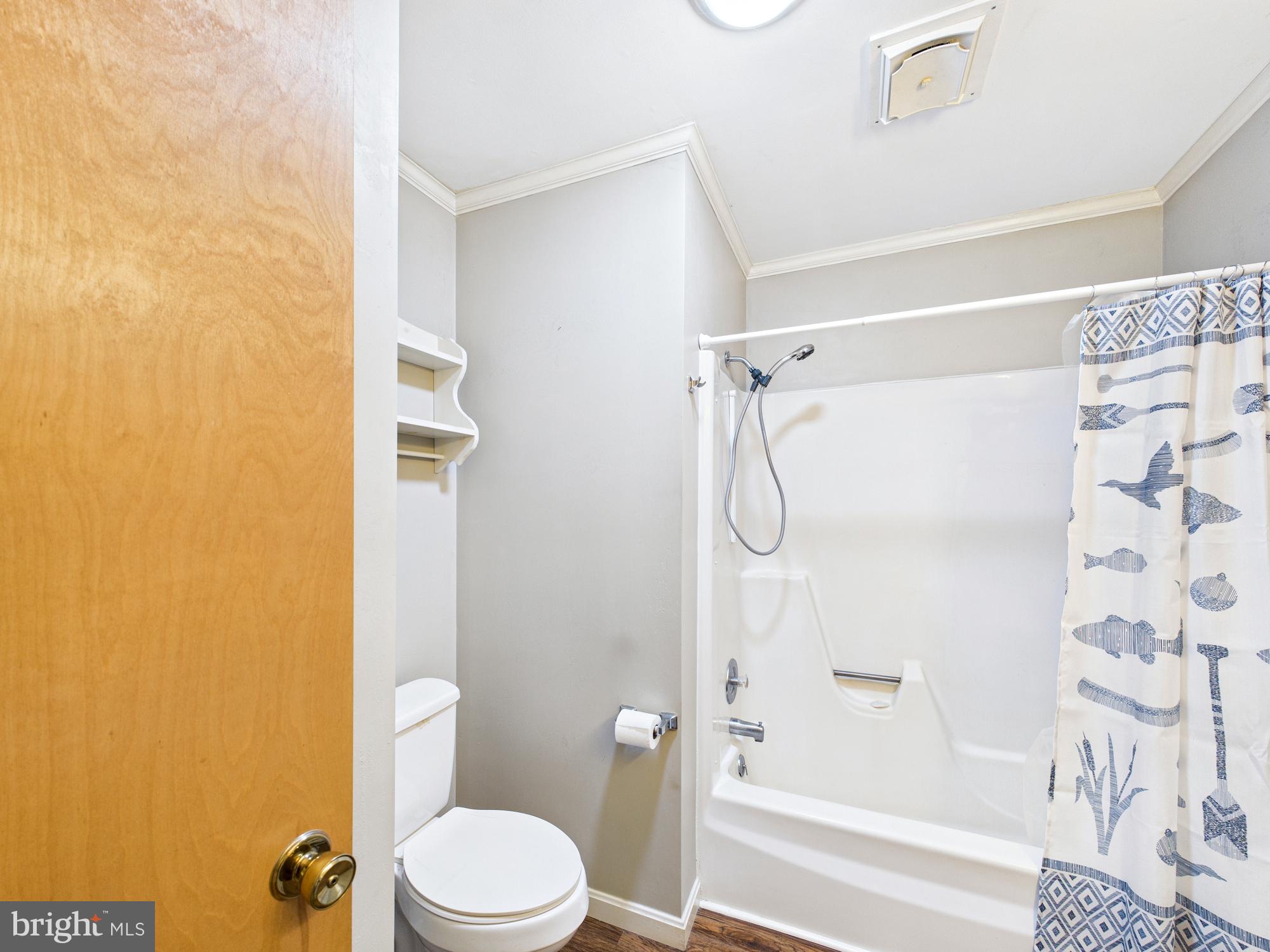 5046 Manokin Road Crisfield, MD 21817 - Photo 34 of 72 a white toilet sitting next to a bath tub