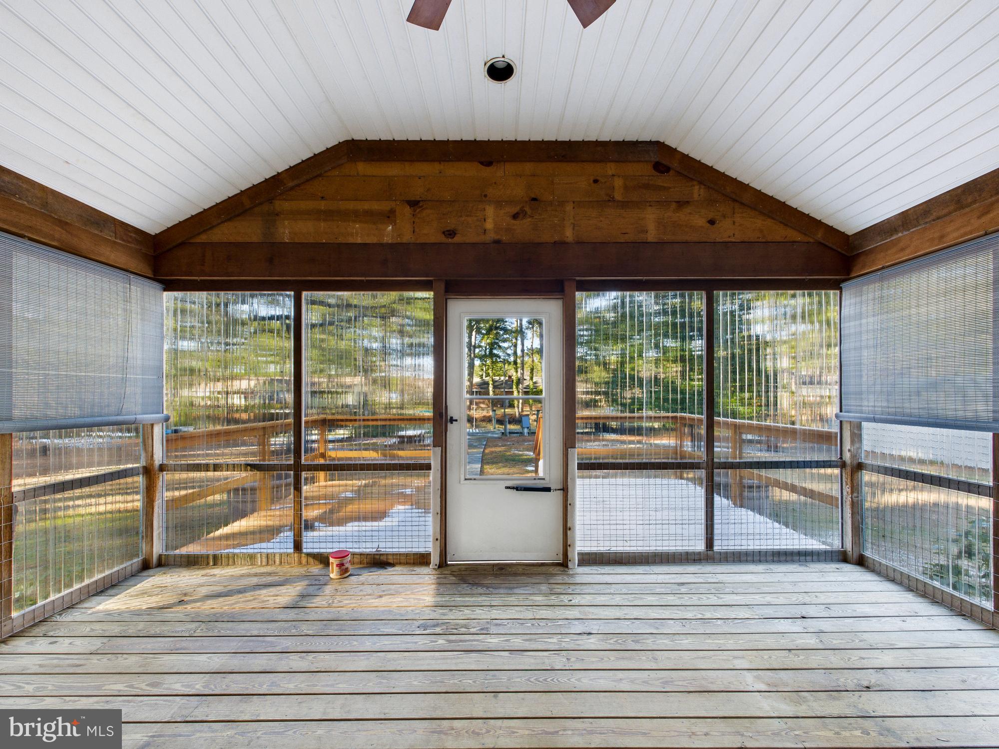 5046 Manokin Road Crisfield, MD 21817 - Photo 37 of 72 wooden floor in an empty room with a window