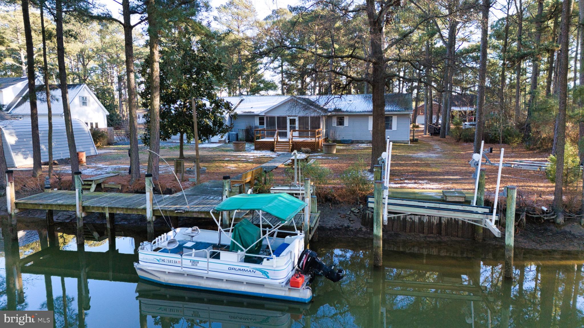 5046 Manokin Road Crisfield, MD 21817 - Photo 4 of 72 a patio with water view fountain and a fire pit