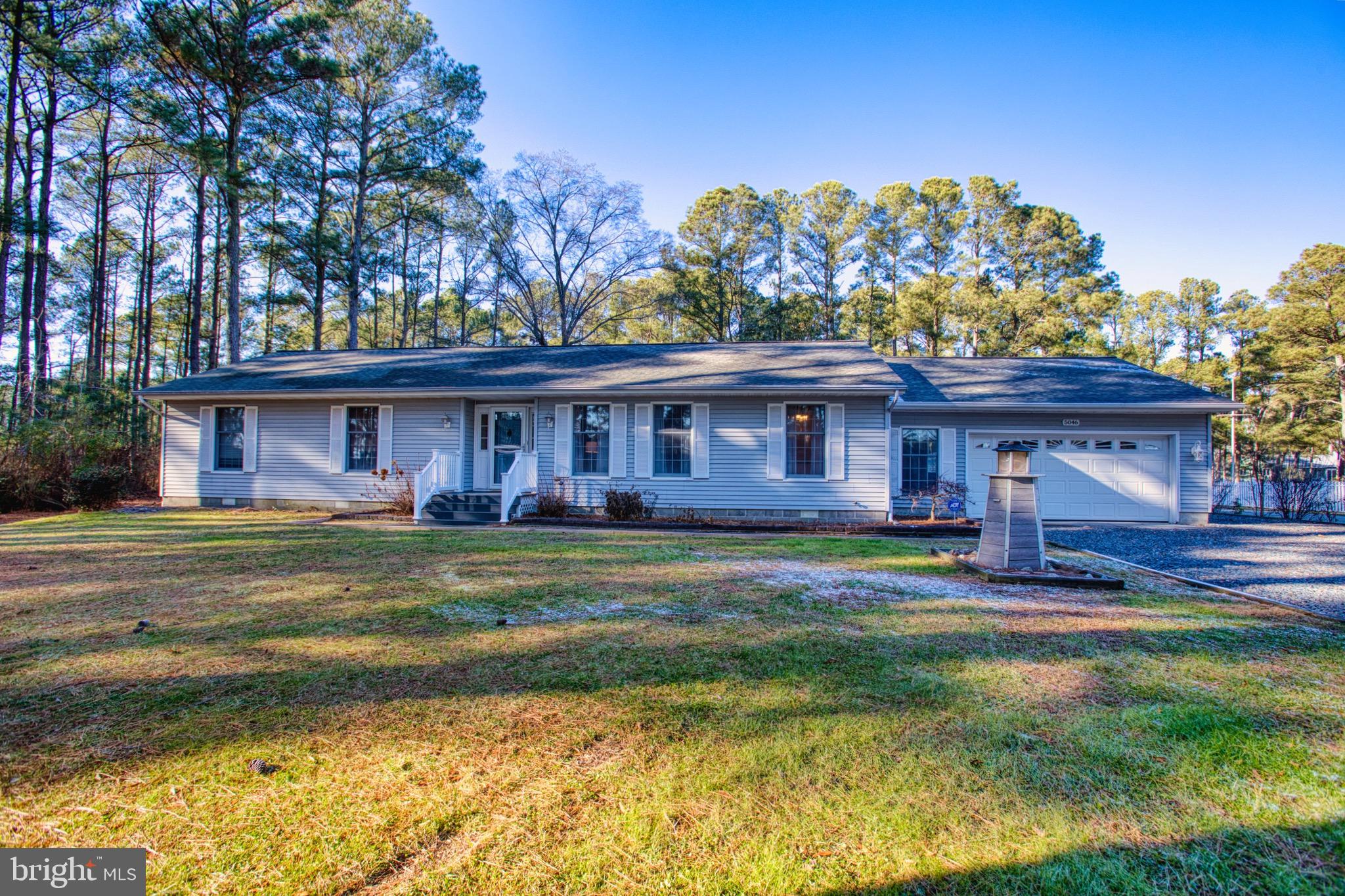 5046 Manokin Road Crisfield, MD 21817 - Photo 70 of 72 a view of a big house with a big yard and large trees