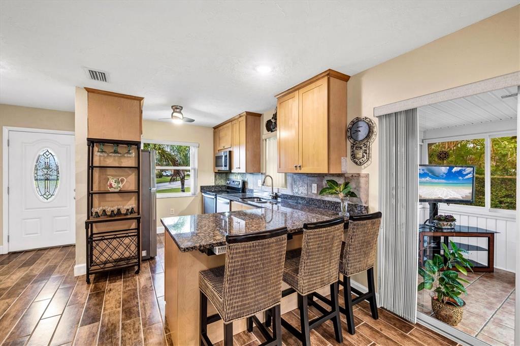 6416 Mercer Road Bradenton, FL 34207 - Photo 11 of 38 a view of a dining room with furniture and wooden floor